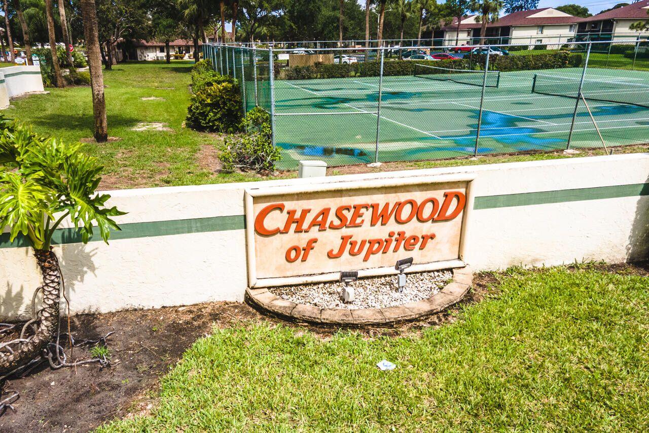 6299 Chasewood Drive, Unit D Jupiter, FL 33458 - Photo 13 of 13 a sign on the side of the road