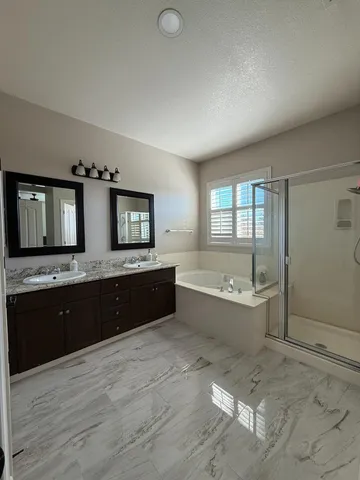 a large bathroom with a large tub and sink
