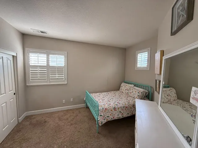 a bedroom with bed and window