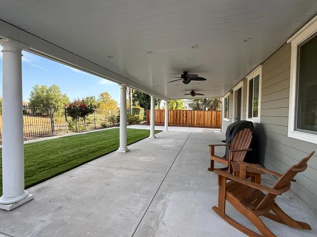 a view of a porch with furniture and garden