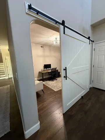 a view of an entryway with wooden floor
