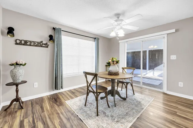 a view of a dining room with furniture window and wooden floor