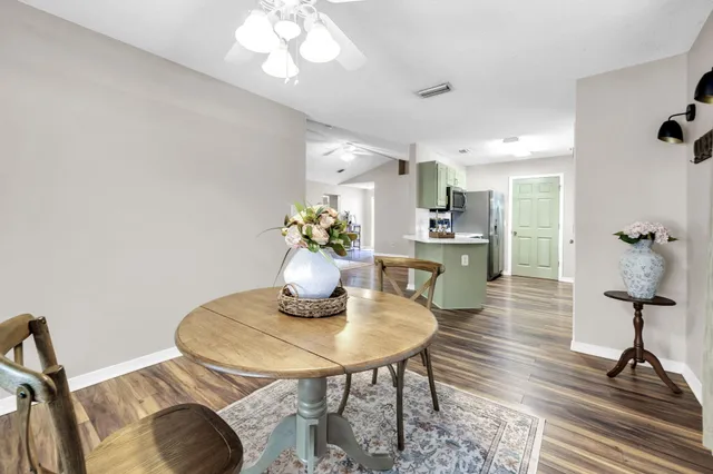 a dining room with furniture and wooden floor