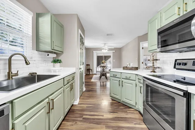 a kitchen with stainless steel appliances granite countertop a sink and stove top oven