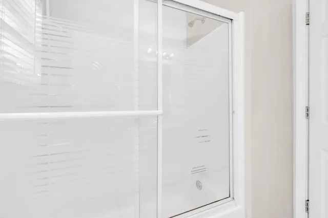 a bathroom with a glass shower door