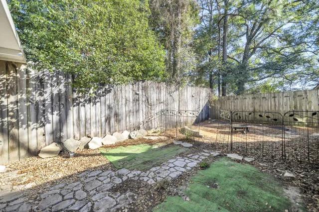 a backyard of a house with a tree