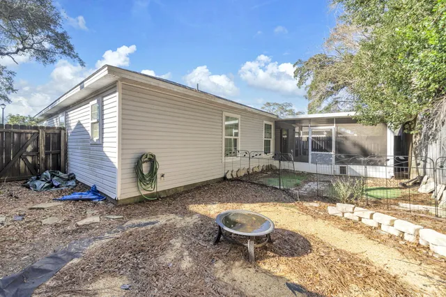 a view of a backyard with a tree