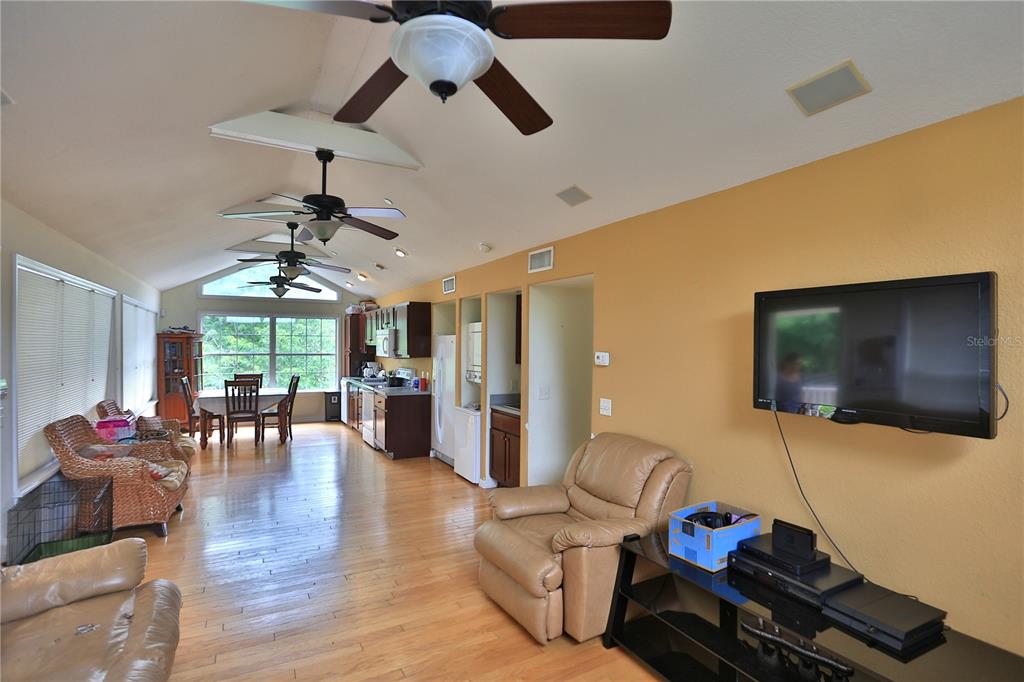 500 Southeast 69th Place Ocala, FL 34480 - Photo 12 of 46 a living room with furniture a flat screen tv and wooden floor