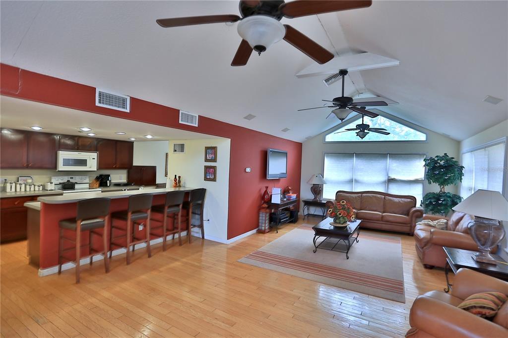 500 Southeast 69th Place Ocala, FL 34480 - Photo 14 of 46 a living room with furniture a wooden floor and a chandelier