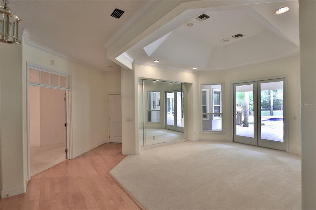 500 Southeast 69th Place Ocala, FL 34480 - Photo 23 of 46 a large bedroom with a large bed and glass door