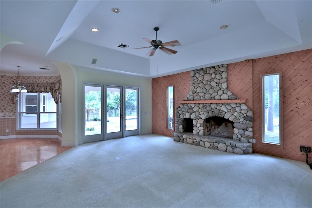 500 Southeast 69th Place Ocala, FL 34480 - Photo 26 of 46 a view of an empty room with a fireplace and a window