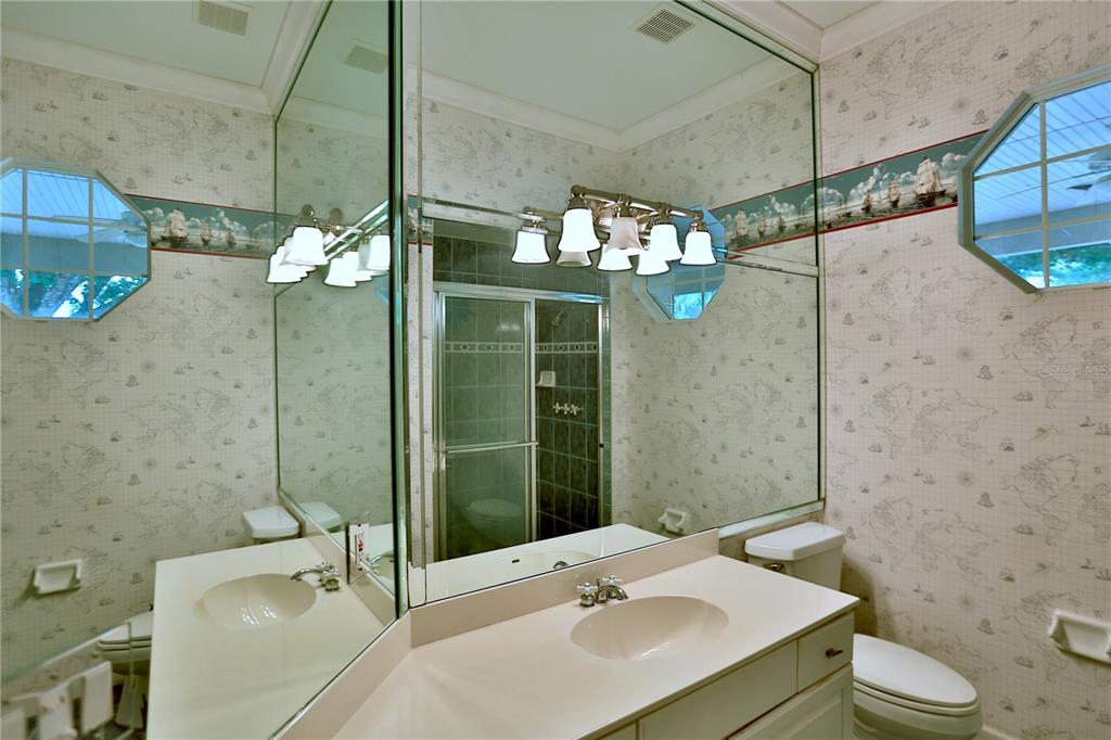 500 Southeast 69th Place Ocala, FL 34480 - Photo 31 of 46 a bathroom with a sink mirror and toilet