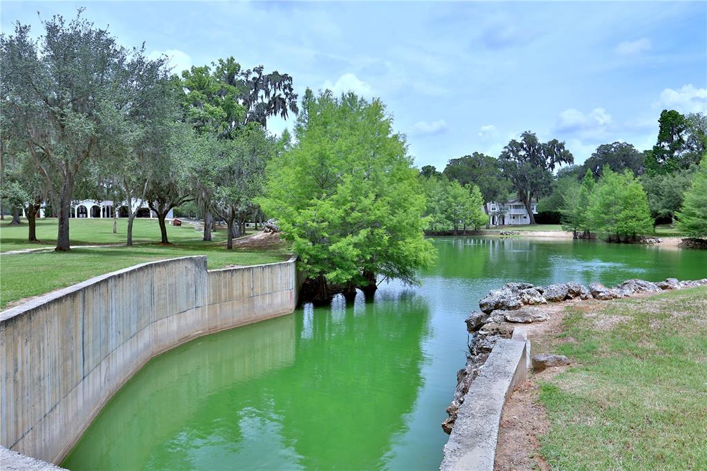 500 Southeast 69th Place Ocala, FL 34480 - Photo 39 of 46 a view of a lake with a yard and large trees