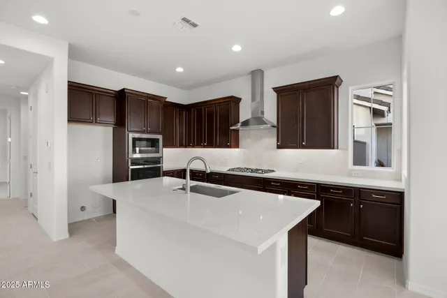 a kitchen with a sink and stainless steel appliances