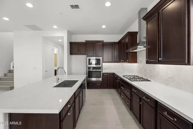 a kitchen with granite countertop a sink and a refrigerator
