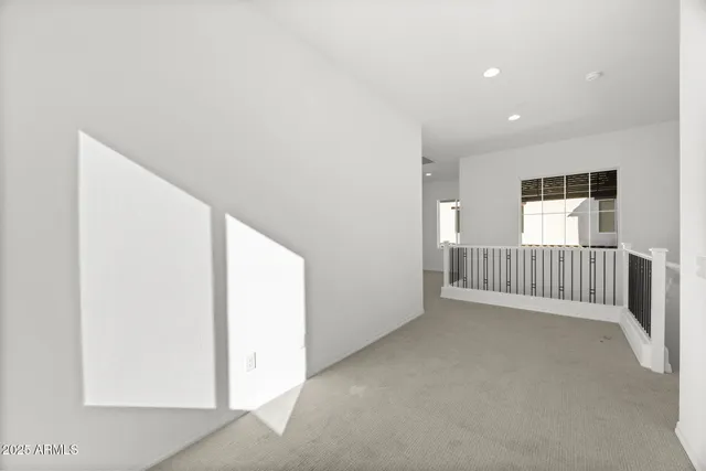 an empty room with a empty space and windows