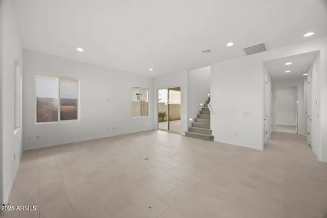 a view of a big room with closet and windows