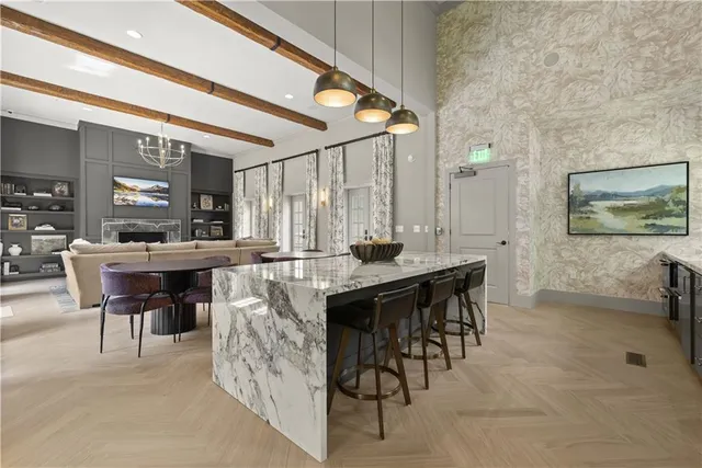 a dining hall with stainless steel appliances kitchen island granite countertop furniture and a large window