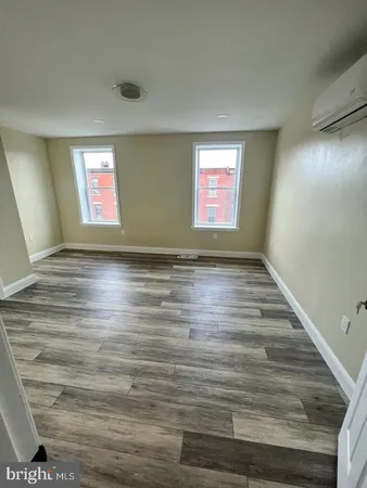a view of room with window and hardwood floor