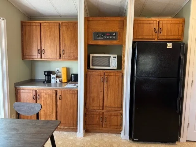 a kitchen with stainless steel appliances granite countertop a refrigerator and a cabinets