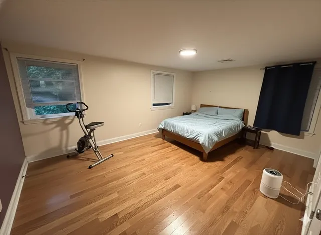 a living room with couch tv and a window