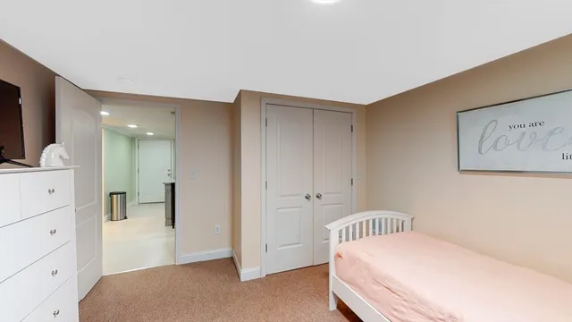 a bedroom with a bed and hallway