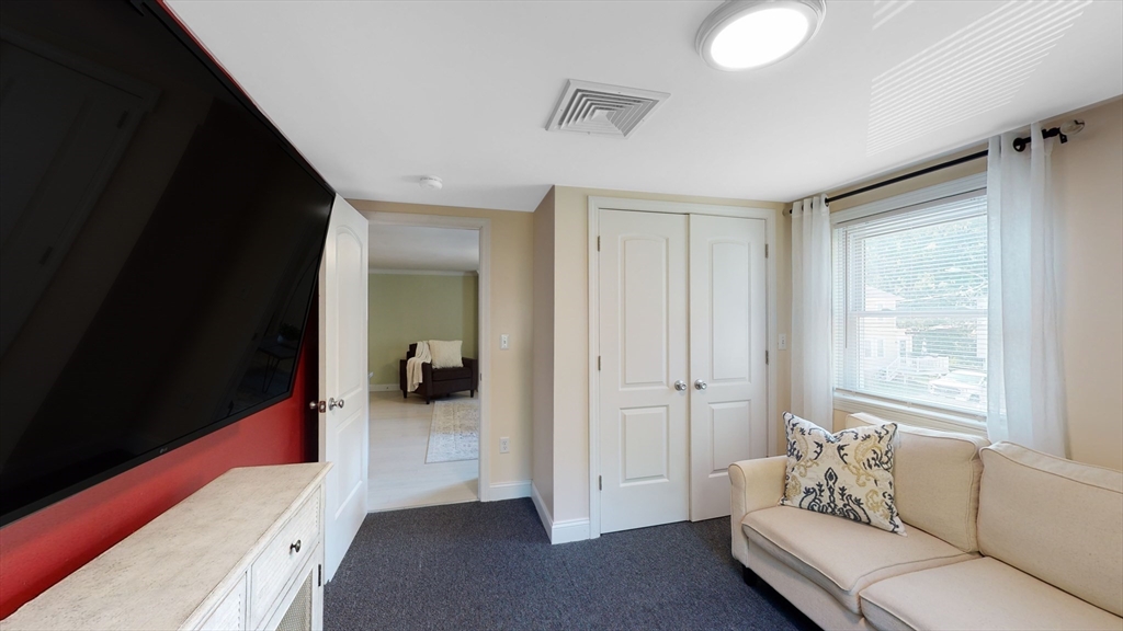10 Riverbank Road, Unit 2 Maynard, MA 01754 - Photo 7 of 13 a living room with furniture and a large window