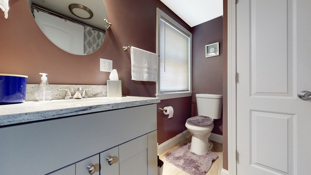 10 Riverbank Road, Unit 2 Maynard, MA 01754 - Photo 9 of 13 a bathroom with a toilet a sink and a mirror