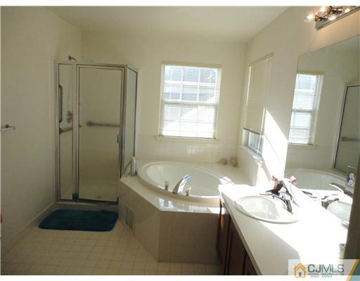 57 Timber Ridge Road North Brunswick, NJ 08902 - Photo 14 of 25 a bathroom with a sink and a bathtub