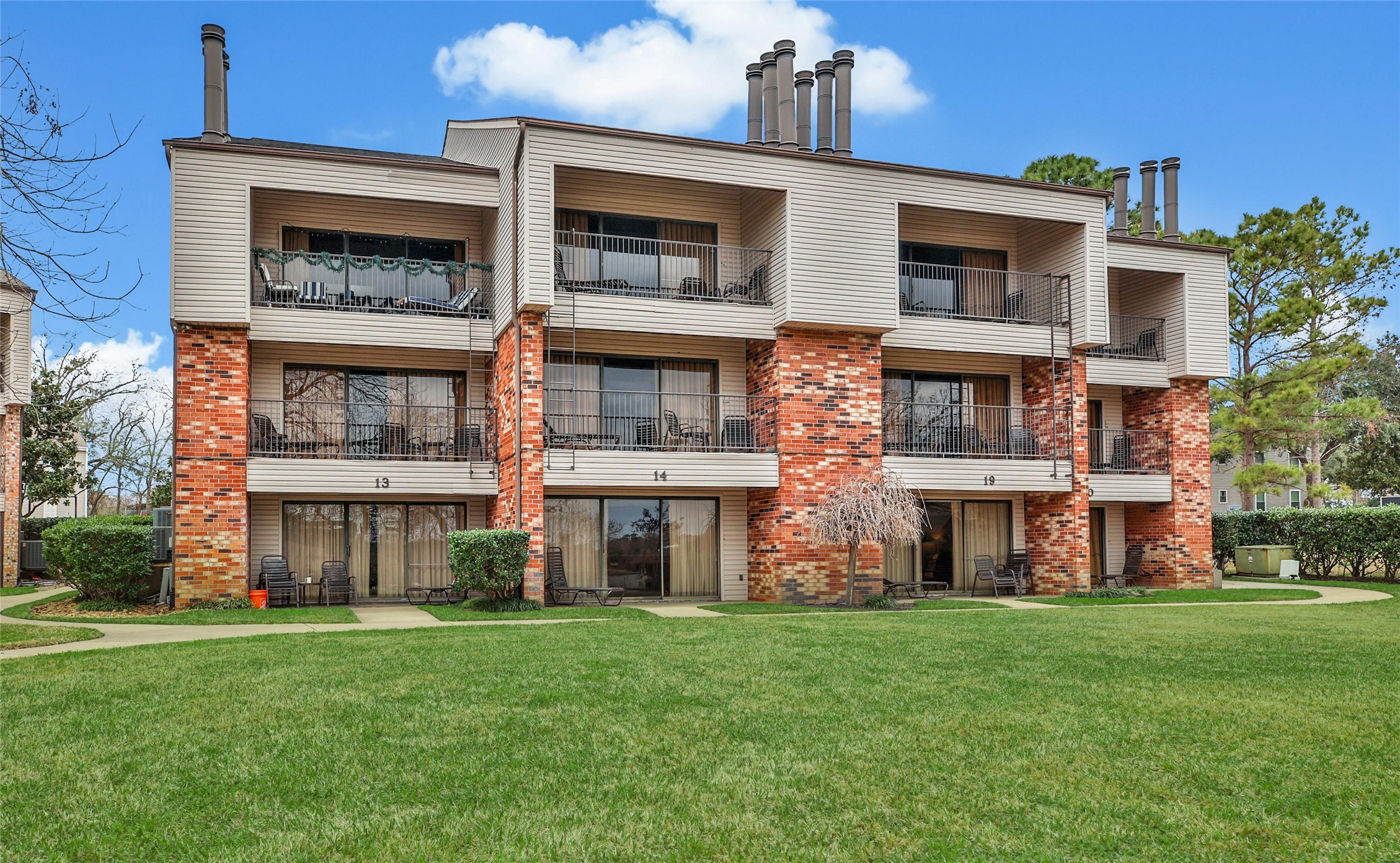 1000 April Sound Boulevard Conroe, TX 77356 - Photo 7 of 46 a front view of a building with a yard