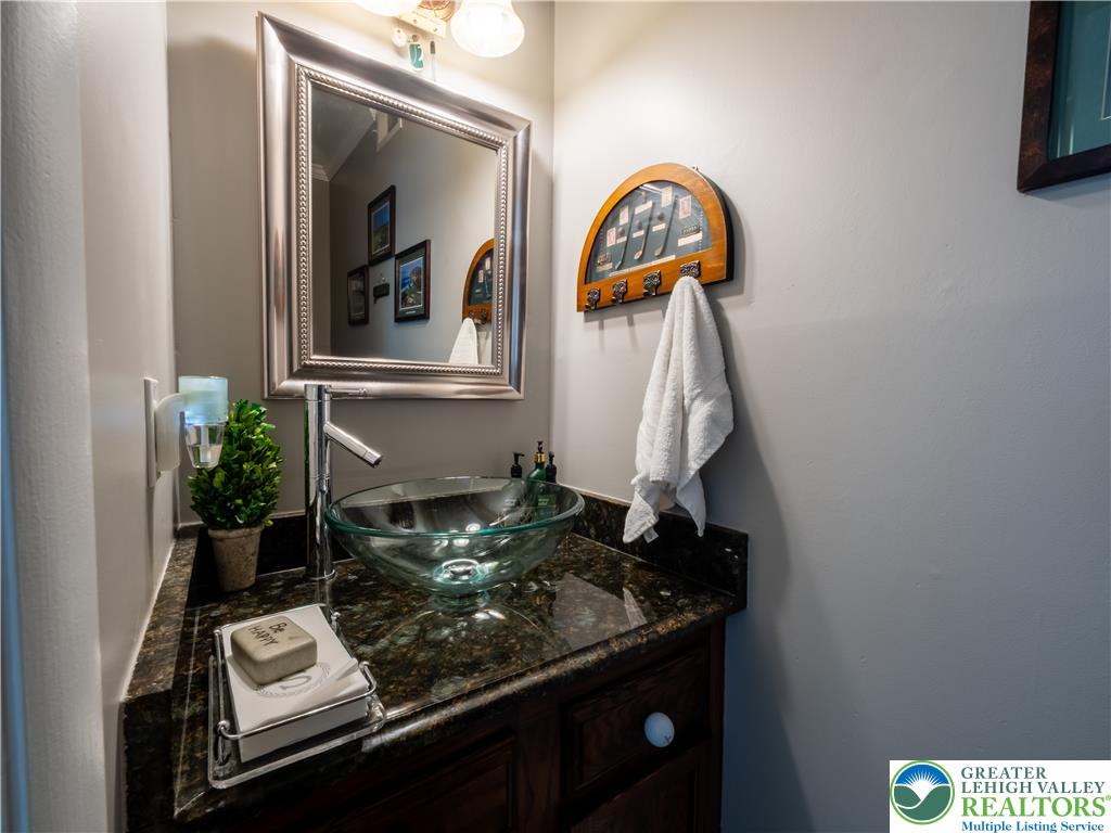 2087 Hopewell Road Bethlehem, PA 18017 - Photo 31 of 38 A stylish glass vessel sink and granite countertop create a refined powder room.