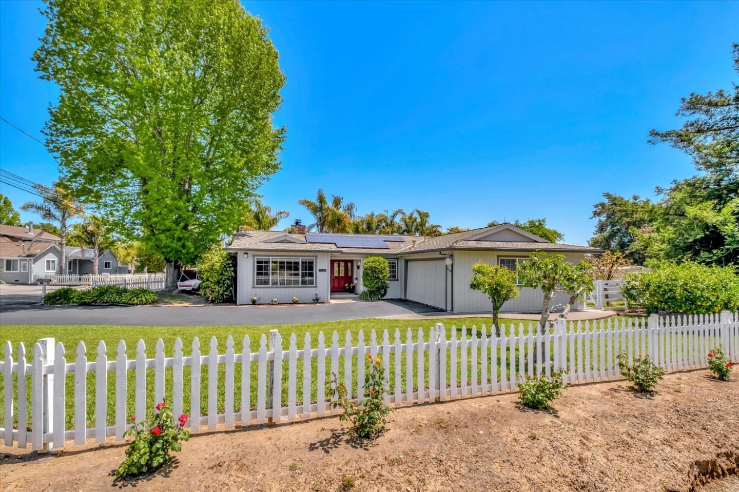 a front view of a house with a garden