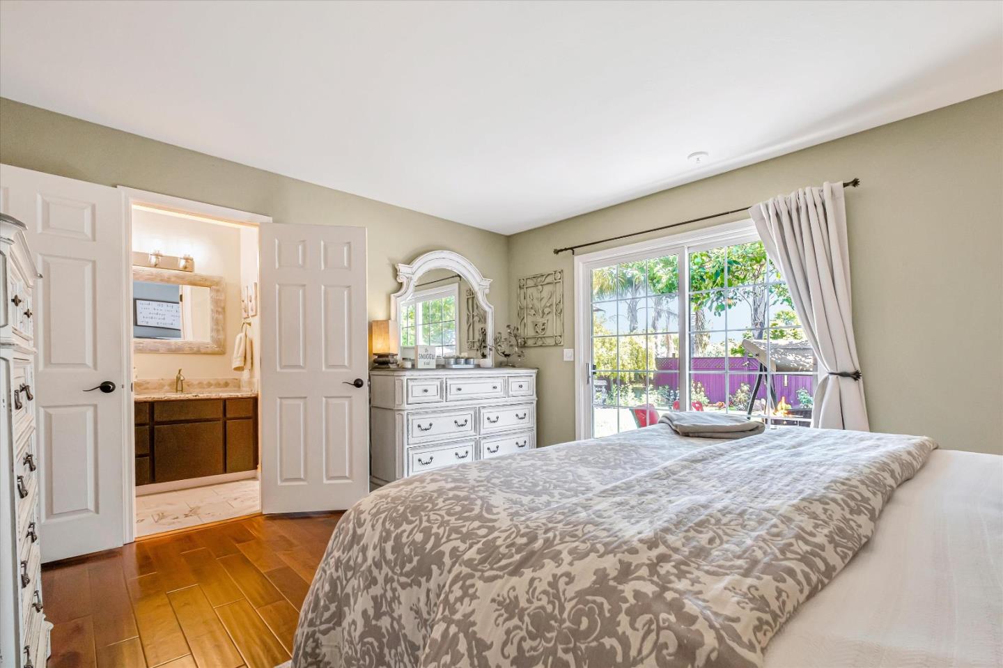 10 Linden Road Watsonville, CA 95076 - Photo 19 of 38 a bedroom with a bed and large windows