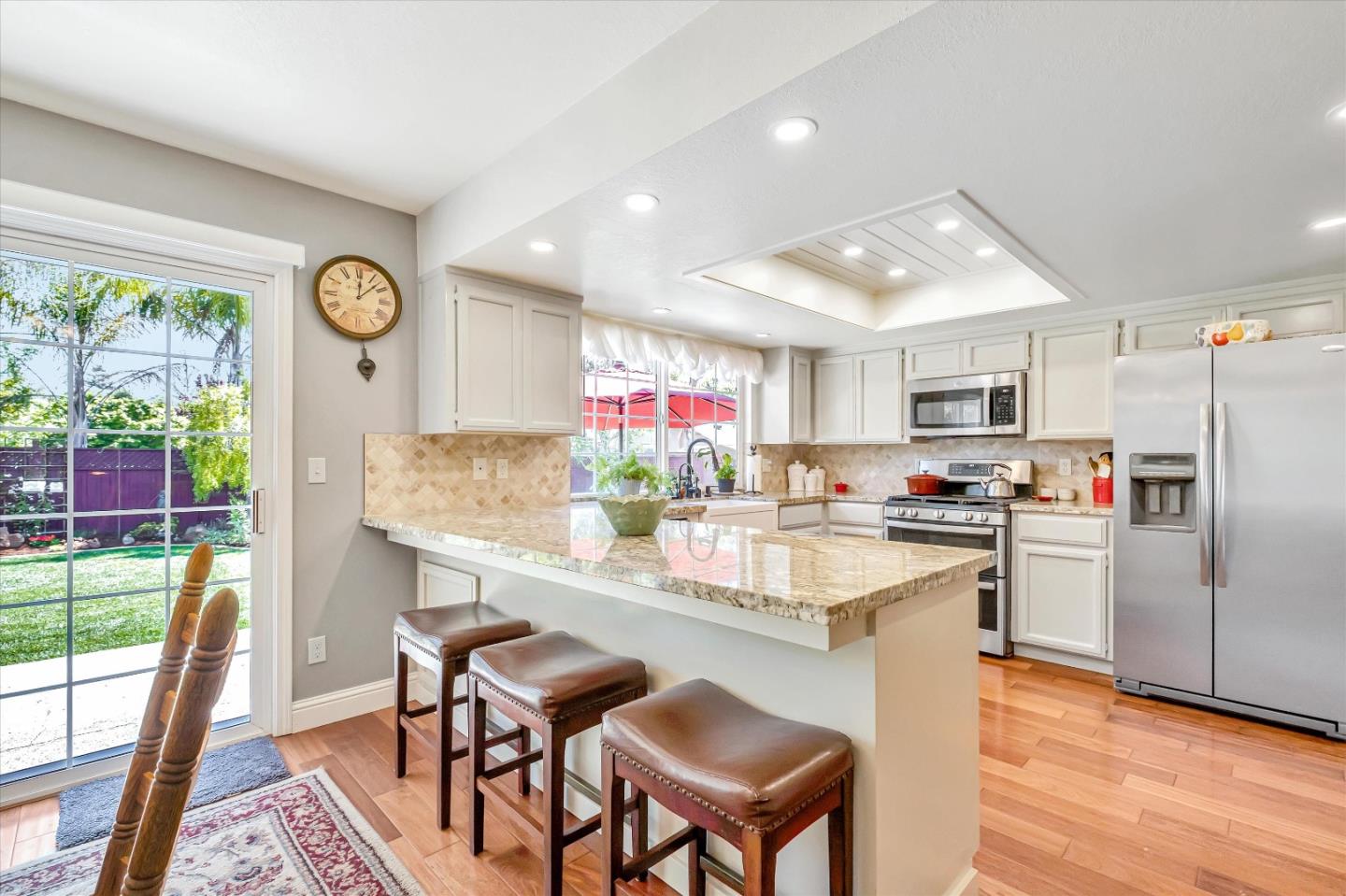 10 Linden Road Watsonville, CA 95076 - Photo 10 of 38 a kitchen with stainless steel appliances granite countertop a refrigerator oven a sink dishwasher and white cabinets with wooden floor