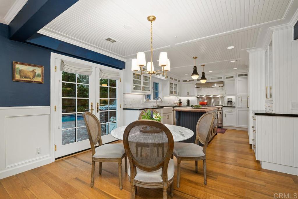 2539 Lone Jack Road Encinitas, CA 92024 - Photo 9 of 37 a dining room with furniture a chandelier and wooden floor