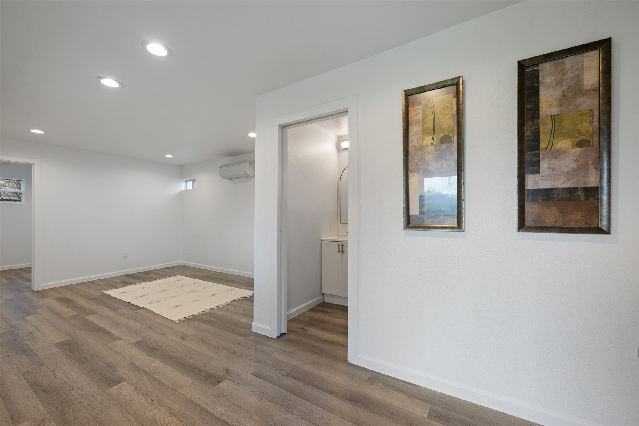 901 Valdez Street, Unit 13 Austin, TX 78741 - Photo 18 of 38 a view of an empty room with wooden floor and a window