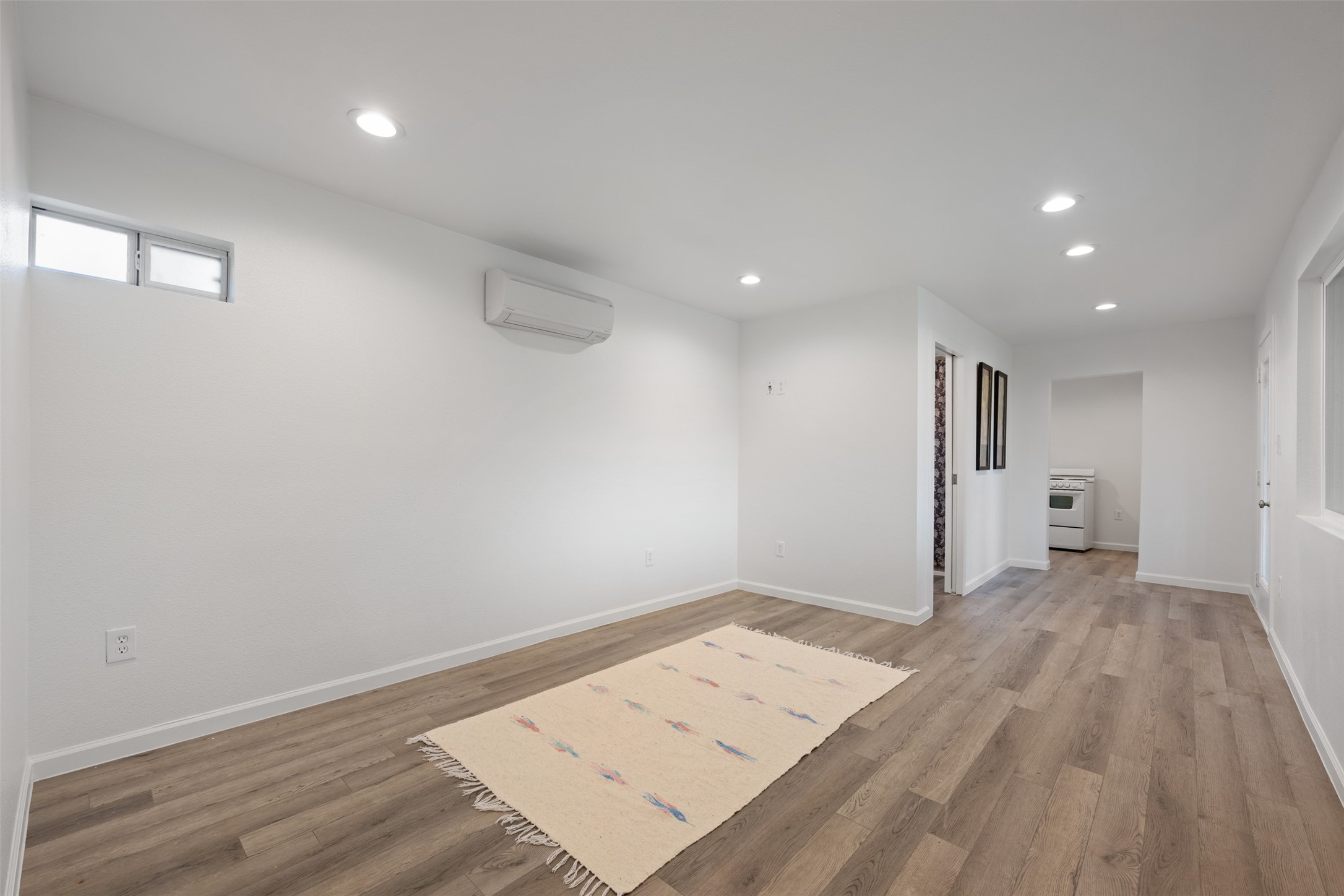 901 Valdez Street, Unit 13 Austin, TX 78741 - Photo 20 of 38 an empty room with wooden floor and windows