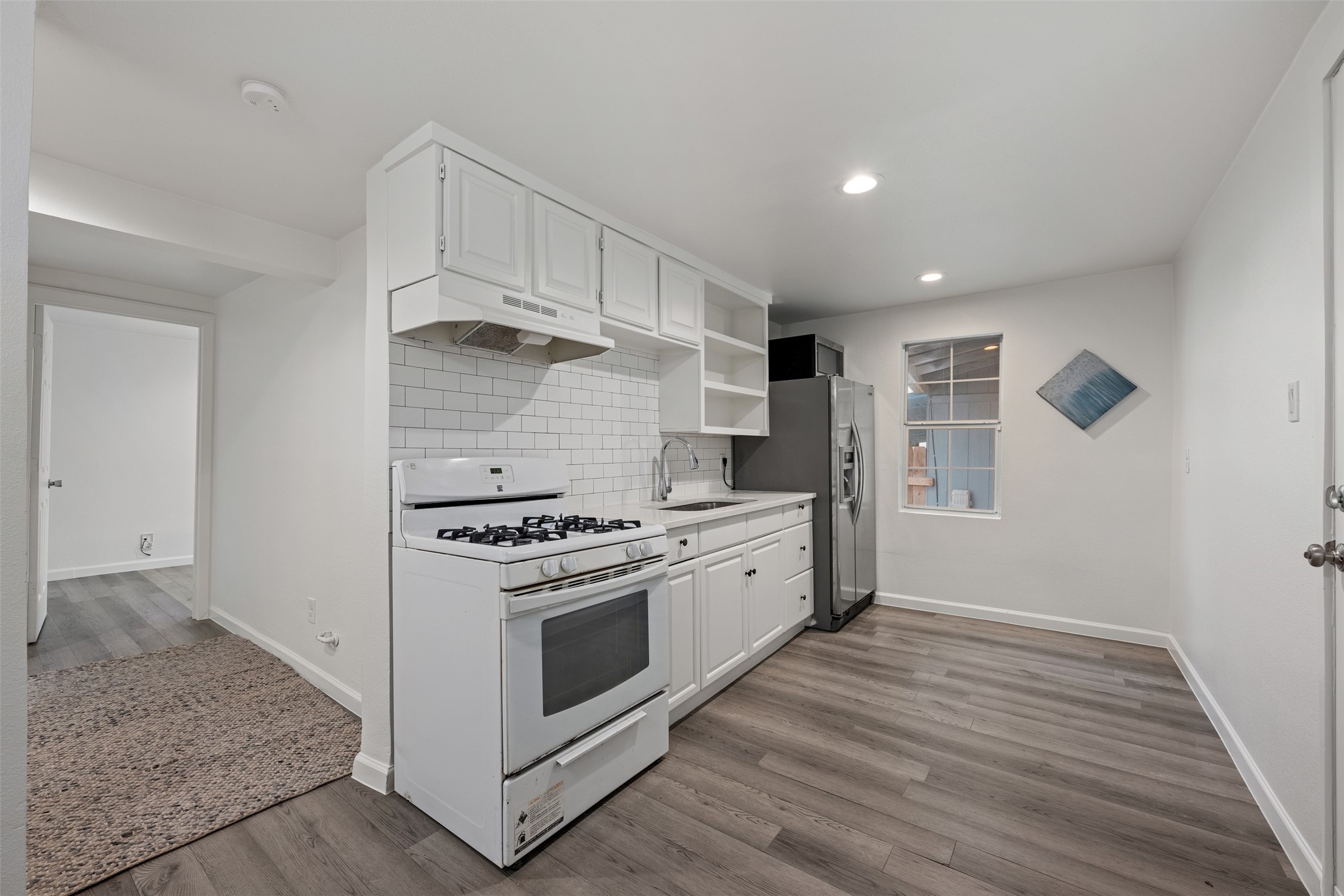 901 Valdez Street, Unit 13 Austin, TX 78741 - Photo 28 of 38 a kitchen with a stove and a wooden cabinets
