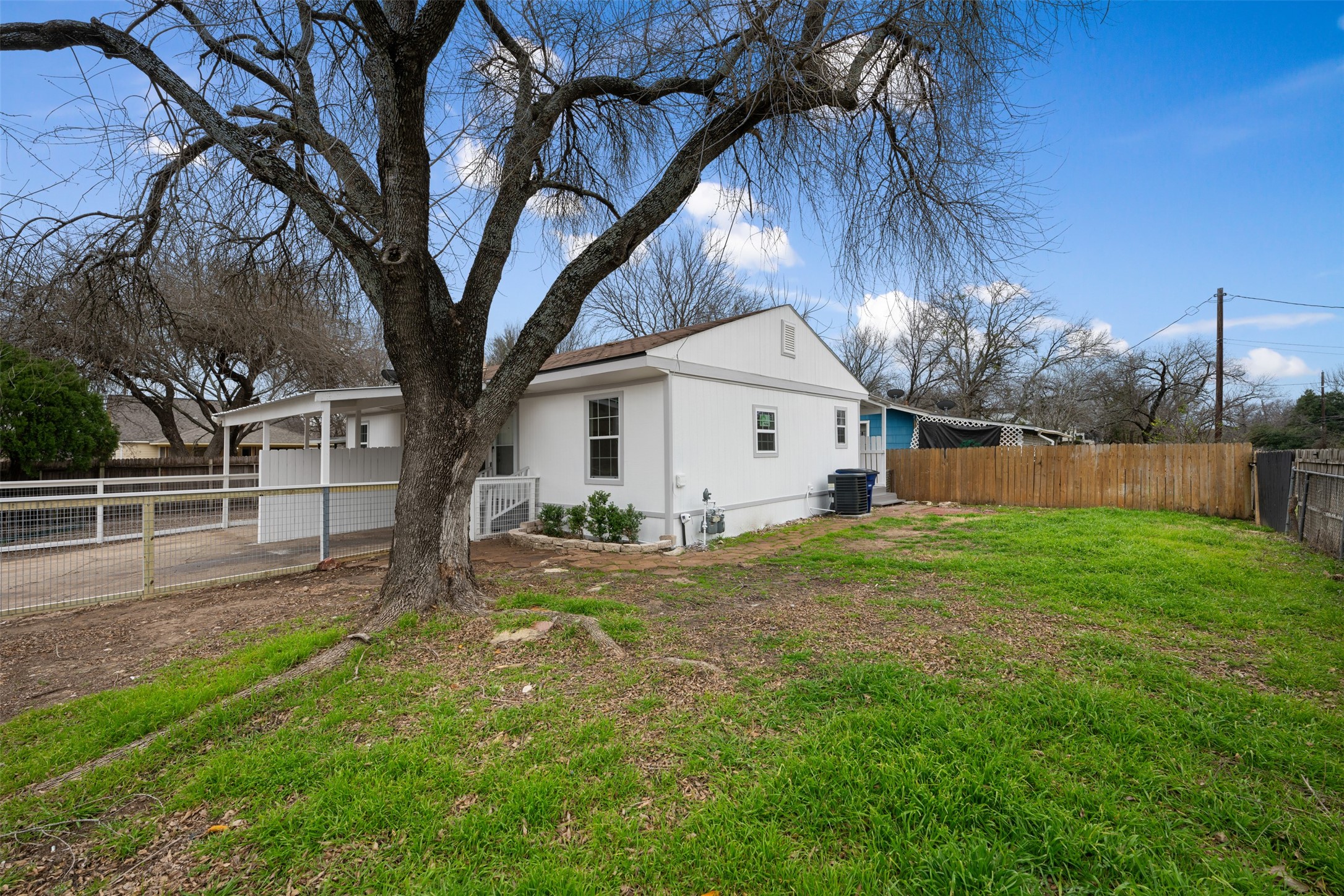 901 Valdez Street, Unit 13 Austin, TX 78741 - Photo 35 of 38 a view of a house with backyard and trees