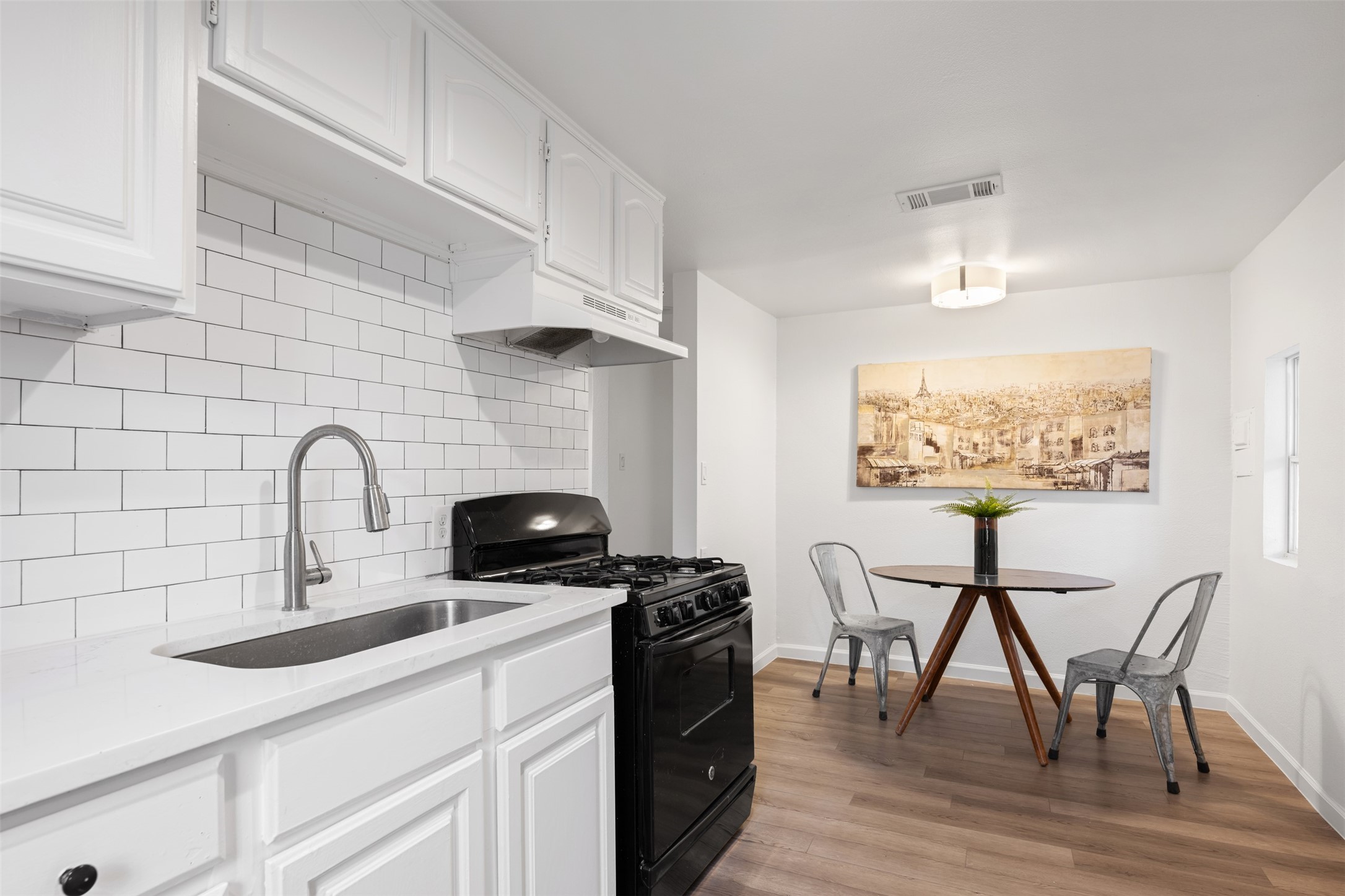 901 Valdez Street, Unit 13 Austin, TX 78741 - Photo 10 of 38 a kitchen with a table chairs and a stove