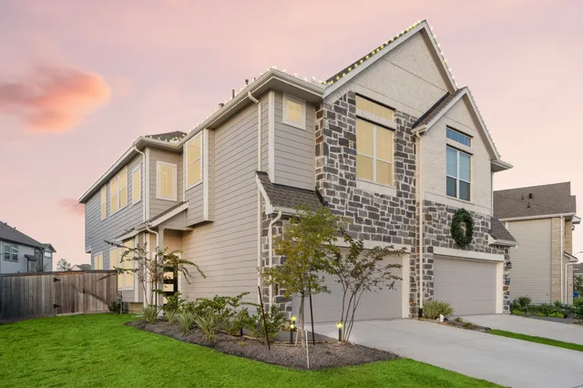 a front view of a house with a yard and trees
