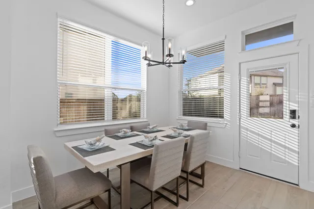 a dining room with furniture and windows