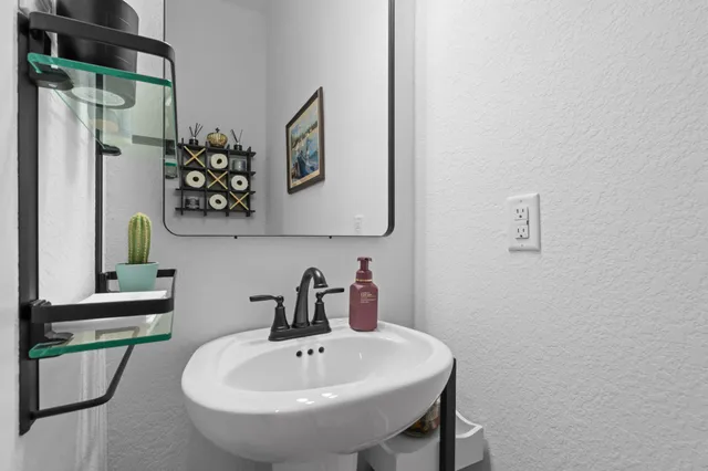 a bathroom with a sink and a mirror