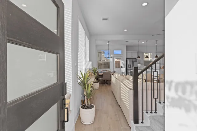 a dining room with furniture and a potted plant