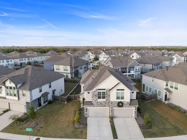 an aerial view of residential houses with a city view