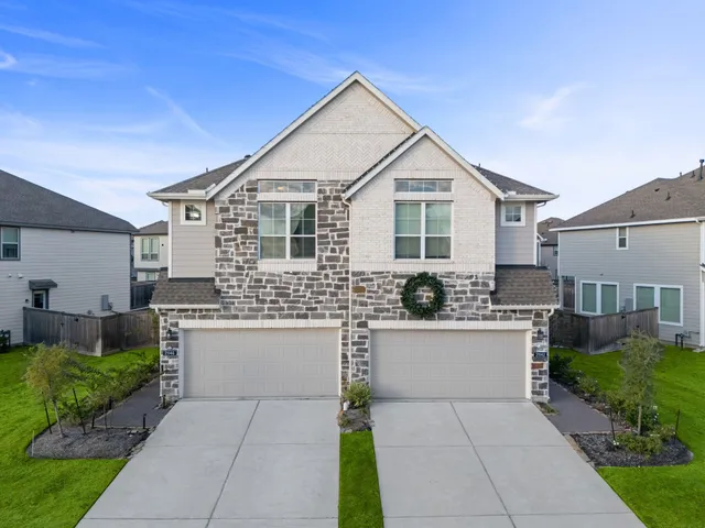 a front view of house with yard and trees in the background