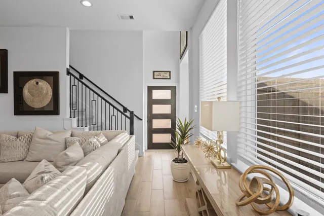 a living room with furniture and wooden floor