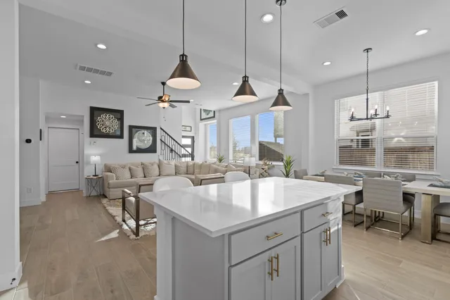 a very nice looking dining room with a large center island and couches