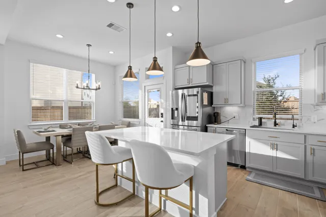 a large kitchen with a table and chairs