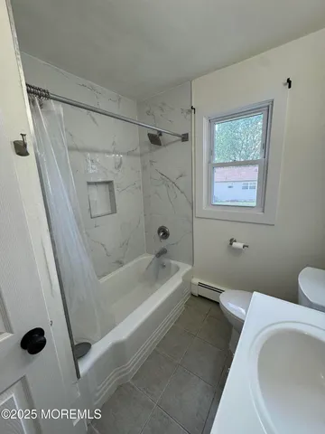 a bathroom with a tub and a shower